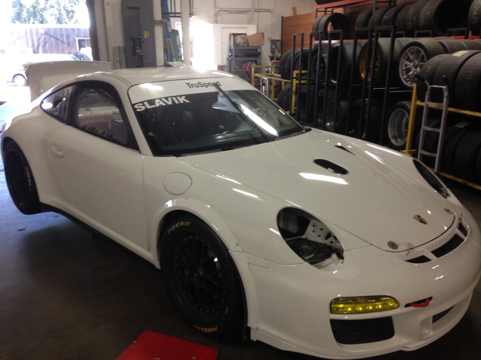 White Porsche GT3 Cup race car with lettering